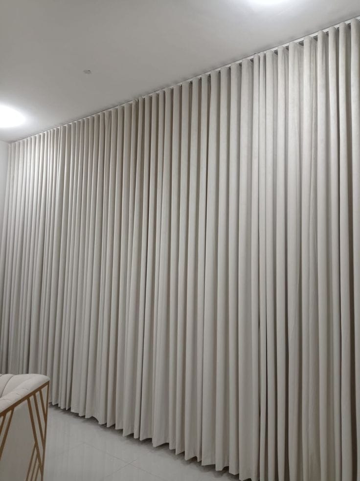 Double-layer curtains with sheer inner panel in a JLT living room