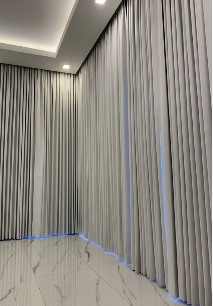 Sun-screen roller blinds on a floor-to-ceiling office facade in Dubai